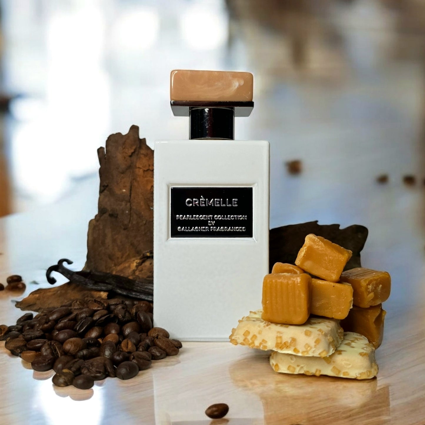 A bottle of Crèmelle fragrance with notes of bergamot, caramel, and vanilla displayed around it, including a piece of crème brûlée, caramel pieces, vanilla beans, and wooden elements.